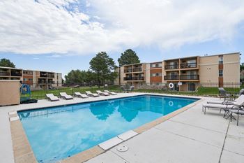 A swimming pool in front of apartment buildings